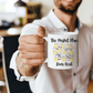 a man holding a coffee mug with the words the project plan