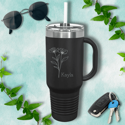 a travel mug next to a pair of sunglasses and keys