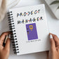 a person holding a notebook with a project manager written on it