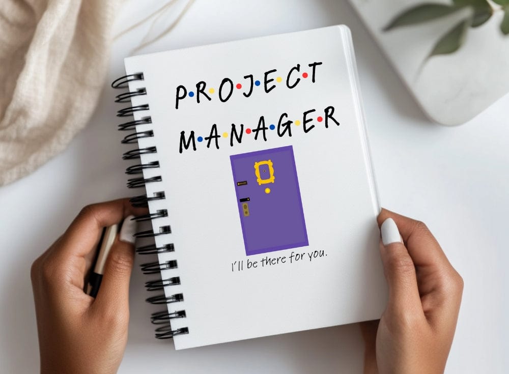 a person holding a notebook with a project manager written on it