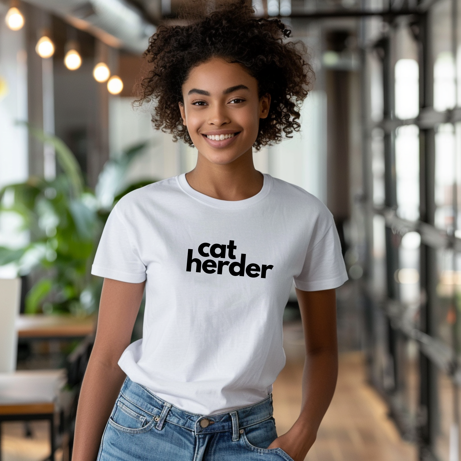 a woman wearing a cat herder t - shirt