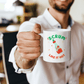 a man holding a coffee mug in his hand