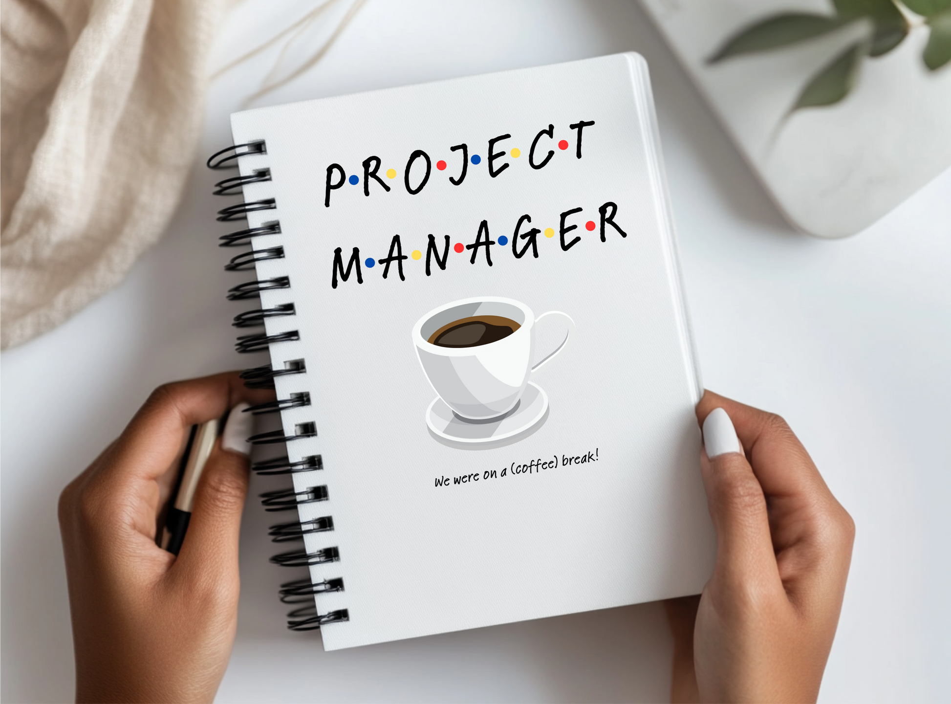 a person holding a notebook with the words project manager written on it