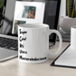 a white coffee mug sitting on top of a desk