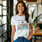 a woman wearing a t - shirt with a picture of a building on it