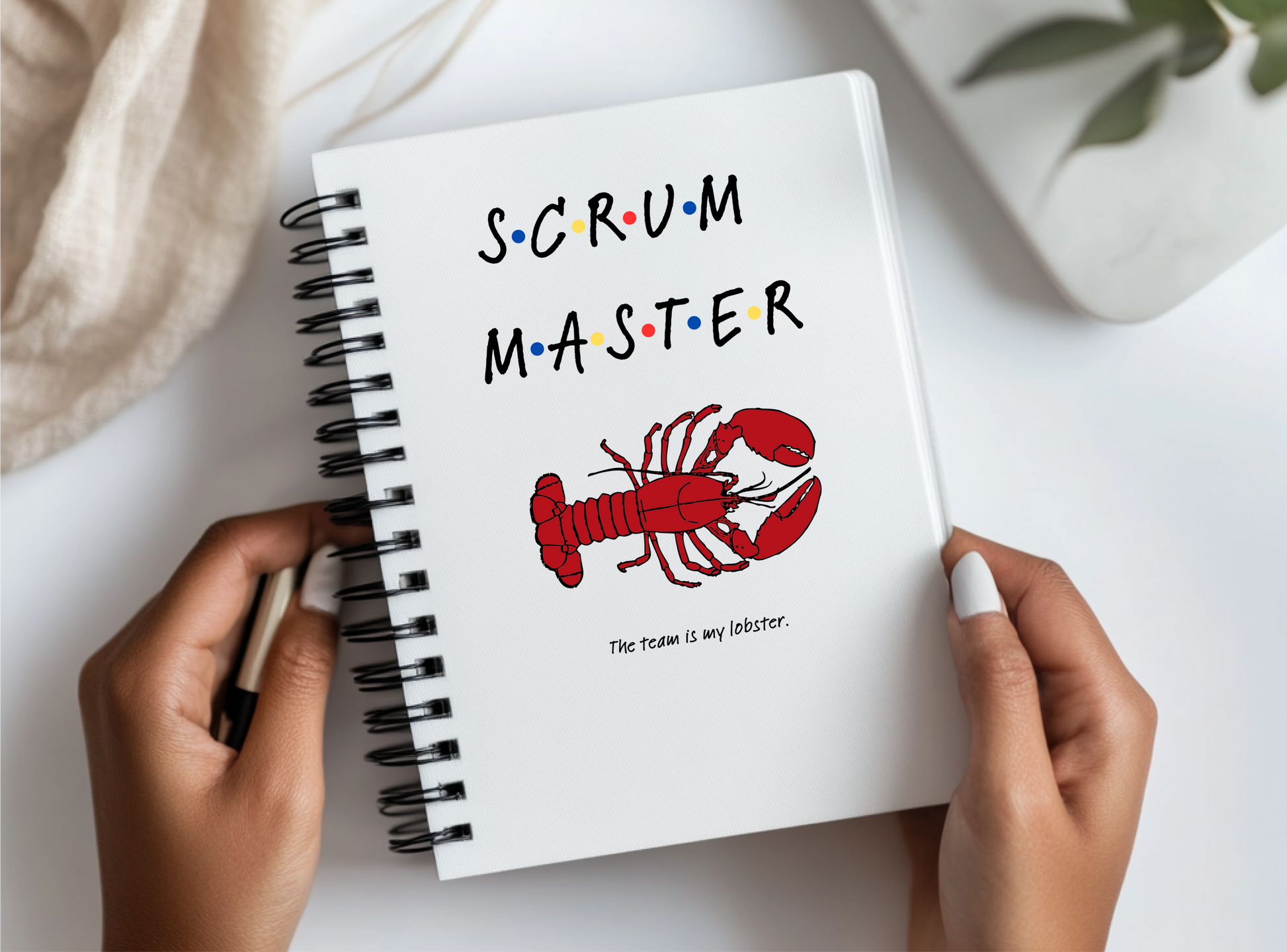 a person holding a notebook with a picture of a lobster on it