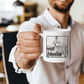 a man holding a coffee mug in his hand