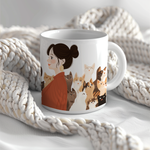 a coffee mug with a picture of a woman surrounded by cats