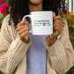 a woman holding a coffee mug in front of her face