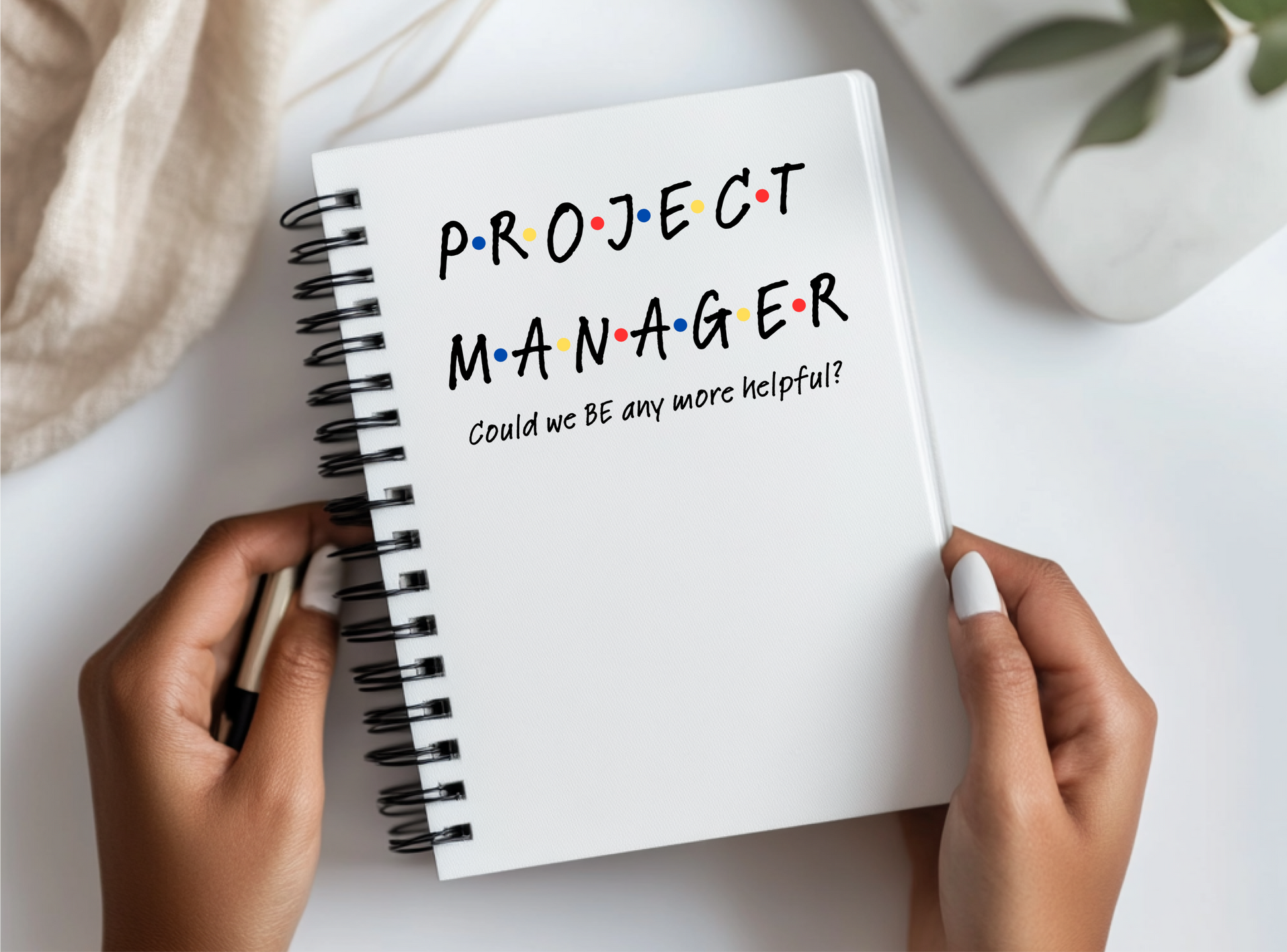 a person holding a notebook with the words project manager written on it