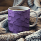 a cup of tea is sitting on a blanket