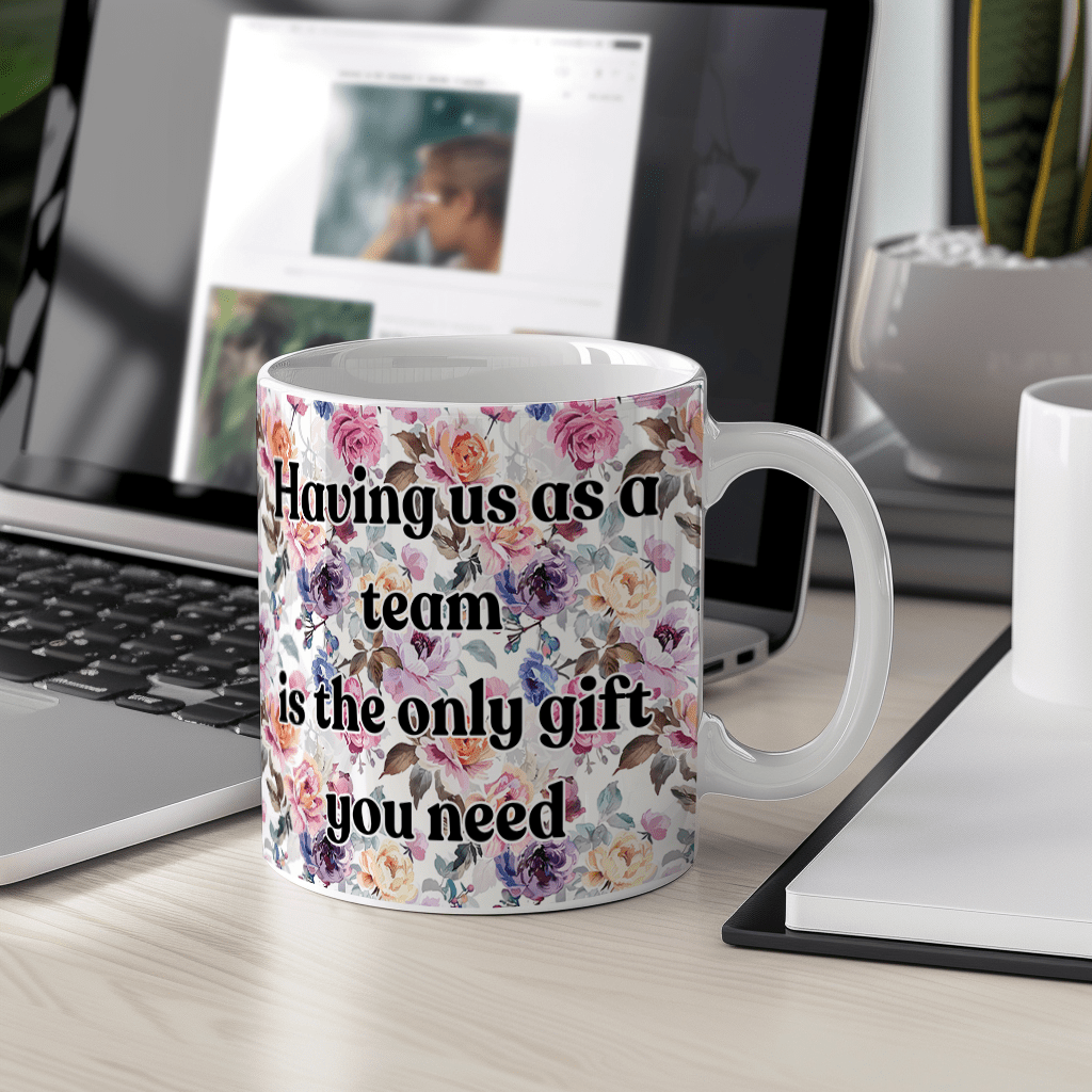 a coffee mug sitting on a desk next to a laptop