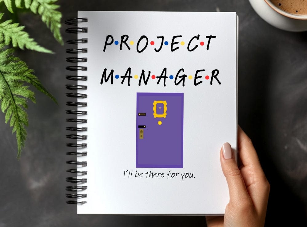 a hand holding a notebook with a project manager written on it