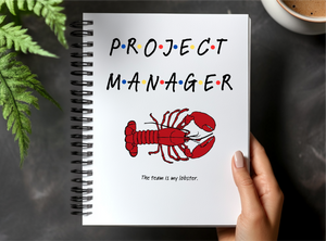 a hand holding a notebook with a picture of a lobster on it