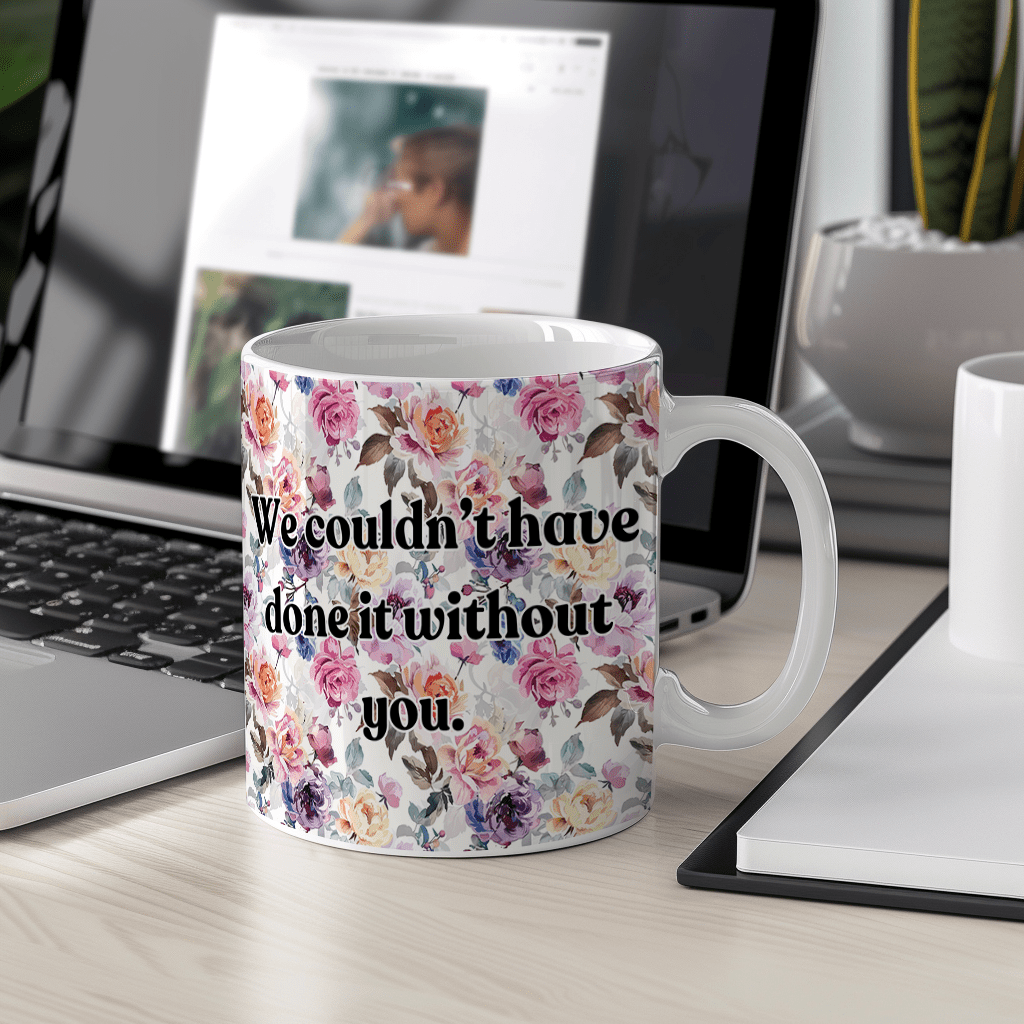 a coffee mug sitting on a desk next to a laptop