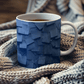 a cup of tea sits on a blanket