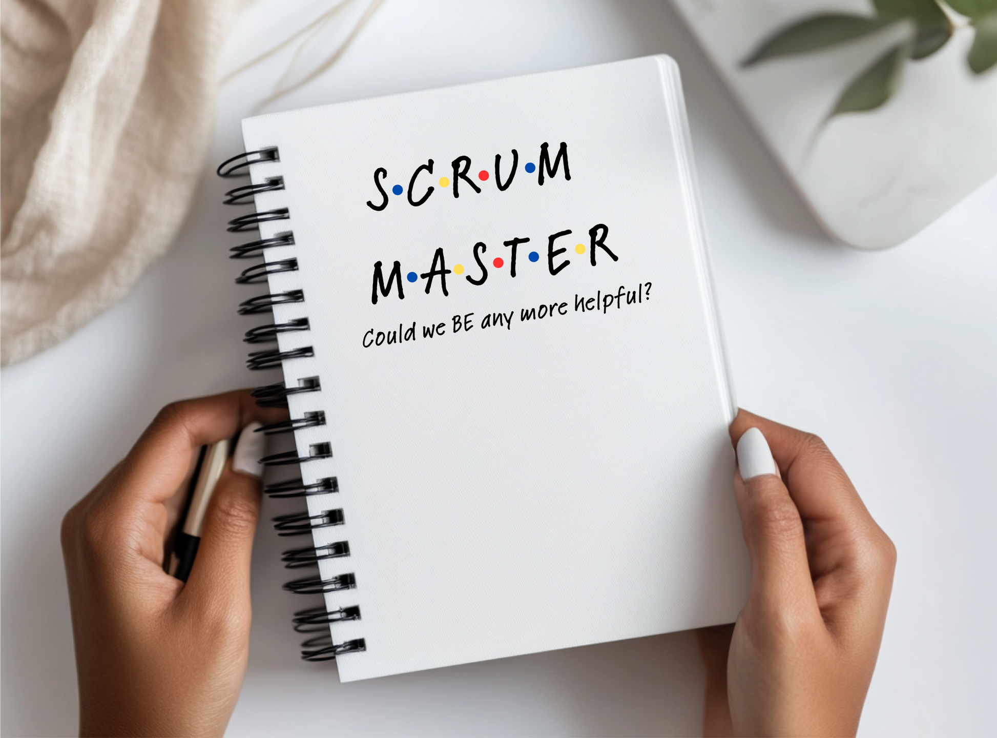 a person holding a notebook with the words scrum master written on it