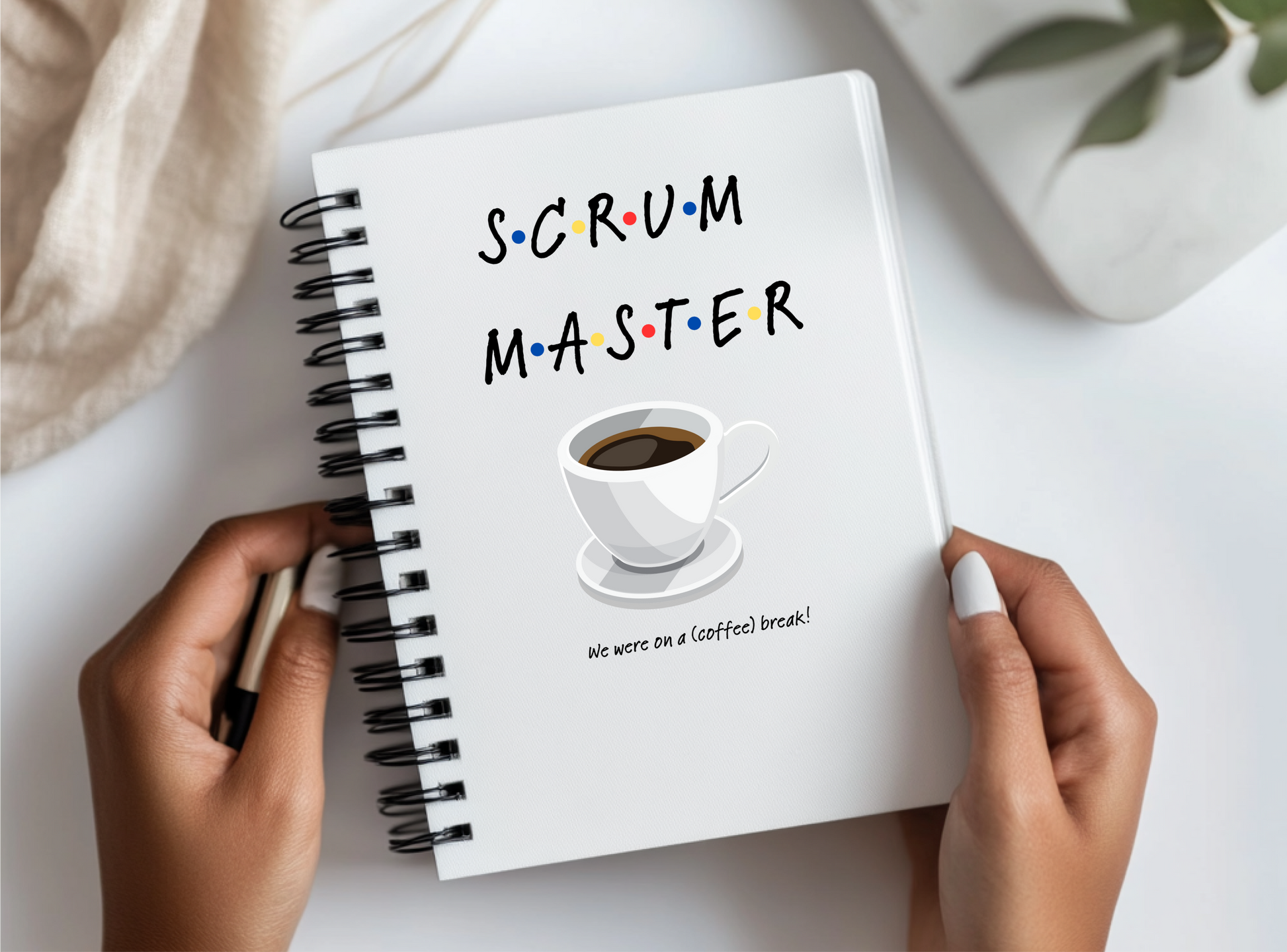 a person holding a notebook with the words scrum master written on it