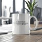 a white coffee mug sitting on top of a wooden table