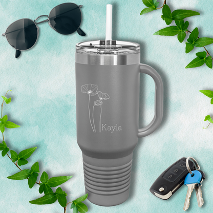 a gray travel mug next to a pair of sunglasses and keys