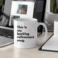 a coffee mug sitting on a desk next to a laptop