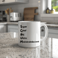 a white coffee mug sitting on top of a counter