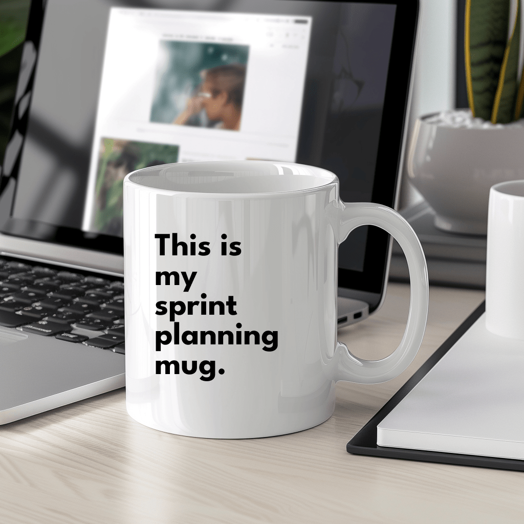 a coffee mug sitting on a desk next to a laptop