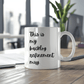 a white coffee mug sitting on top of a wooden table