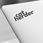 a catherder sticker on the keyboard of a laptop