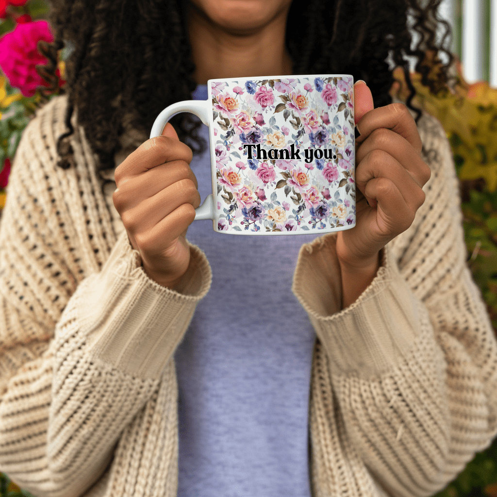 a woman holding a coffee mug with the words thank you