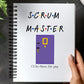 a hand holding a notebook with the words scrum master on it