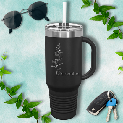 a black tumbler cup next to a pair of sunglasses and a pair of keys