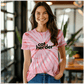 a woman wearing a catherder shirt standing in a room