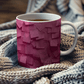 a cup of tea is sitting on a blanket