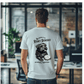 a man standing in an office with a t - shirt on