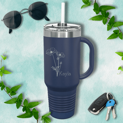 a travel mug next to a pair of sunglasses and keys