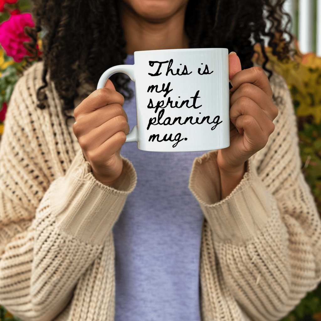 a woman holding a coffee mug with a message on it