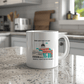 a white coffee mug sitting on top of a kitchen counter